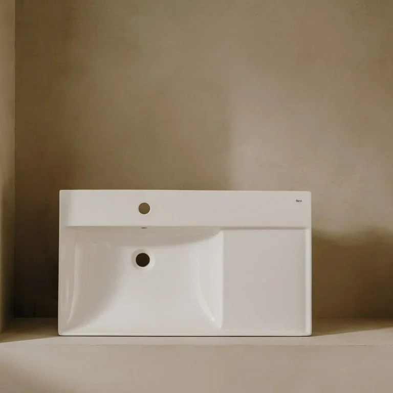 Asymmetric wall-hung Fineceramic® basin with fixing kit